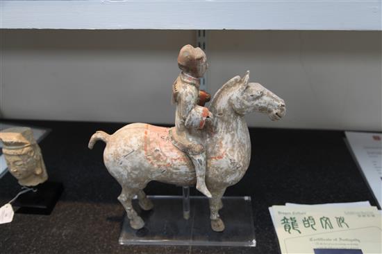A Chinese pottery group of a horse and rider, Han dynasty, height 35cm, length 33.5cm